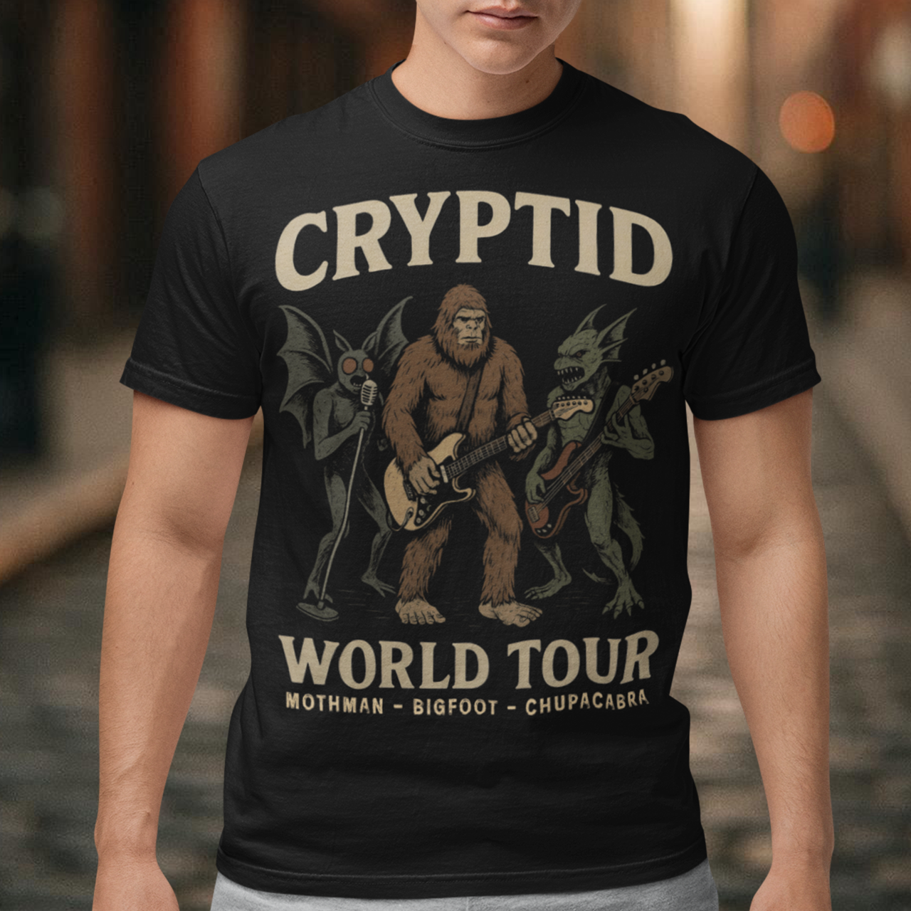 Rock out with legends from beyond the myths! This bold graphic tee features Mothman, Bigfoot, and the Chupacabra shredding as a rock band, headlining the CRYPTID WORLD TOUR. With vintage concert-poster vibes, it’s the perfect blend of spooky lore and rock ’n’ roll energy.
