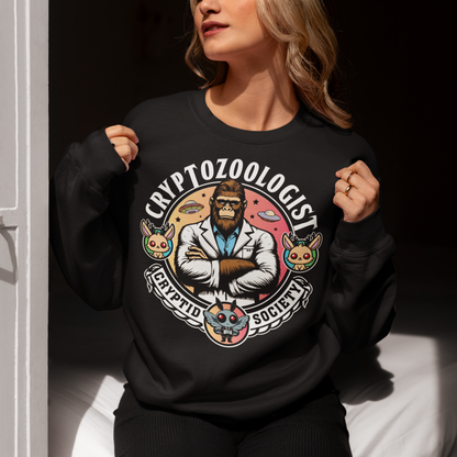 Introducing our enigmatic Cryptozoologist sweatshirt, where the mysteries of the unknown converge in an eye-catching design! Picture this: a towering Bigfoot, not merely a creature of folklore, but an esteemed scientist of the wilderness. Behind this enigmatic figure, the night sky is alive with the shimmering presence of UFOs, hinting at extraterrestrial encounters and the secrets they may hold.