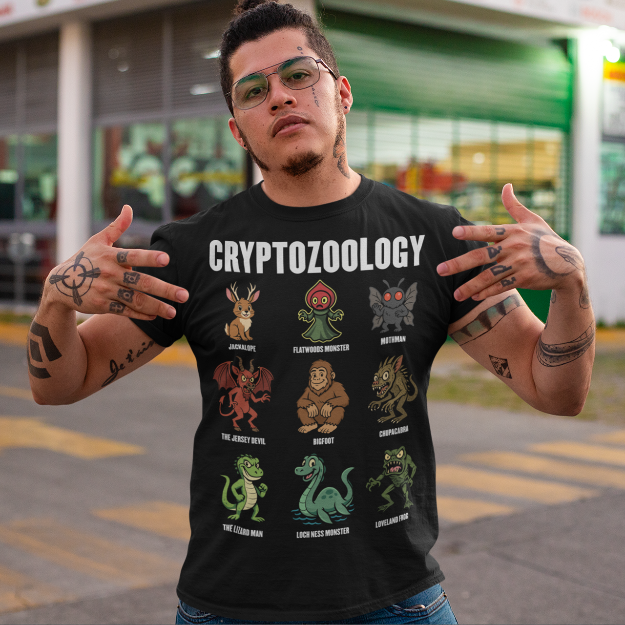 This black graphic tee celebrates the strange and wonderful world of cryptozoology with a lineup of iconic cryptids, each illustrated in a playful, cartoon style. From Bigfoot and Mothman to the Loch Ness Monster, Chupacabra, and Jersey Devil, the design reads like a greatest-hits roster of legendary creatures that lurk just beyond the edge of belief. Bold “Cryptozoology” lettering tops the grid, giving it the feel of a vintage science chart with a fun, modern twist.