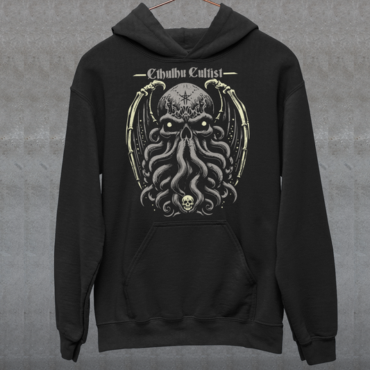 Unleash your dark allegiance with this bold graphic tee featuring a haunting skull-faced Cthulhu design. Tentacles twist and coil beneath a menacing skeletal visage, merging death and madness in one unforgettable image. Above the ancient cosmic horror, the words “Cthulhu Cultist” loom in eldritch-style lettering, marking you as a devoted follower of the Great Old One. Perfect for fans of Lovecraftian horror, dark fantasy, or anyone drawn to the mysterious depths of the unknown.