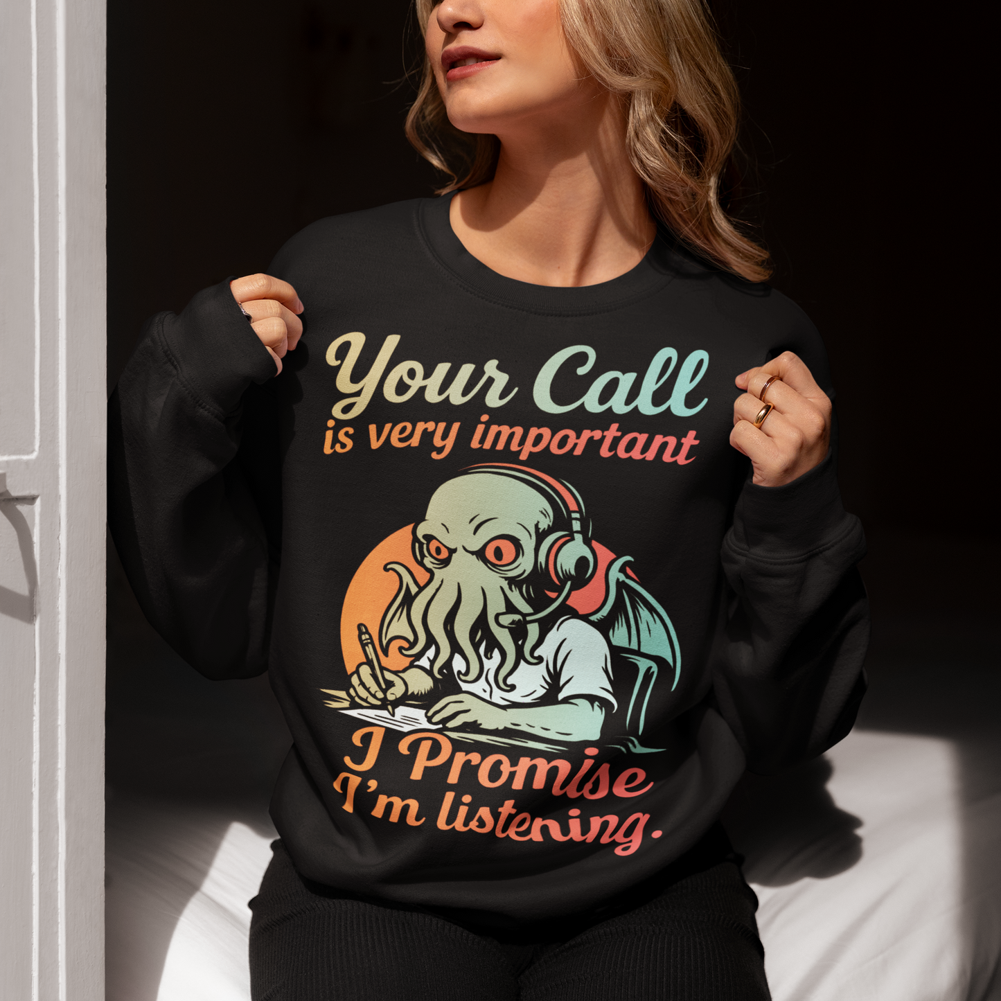 This sweatshirt drops Cthulhu into the fluorescent glow of a call centre desk, headset perched, tentacles multitasking like a cosmic customer-service pro. The vintage colors and playful lettering give it a warm, retro hum while the great old one pretends to take notes. It’s a perfect pick for anyone who has survived hold music, worships dark humor, or simply enjoys mythic chaos wrapped in office casual.