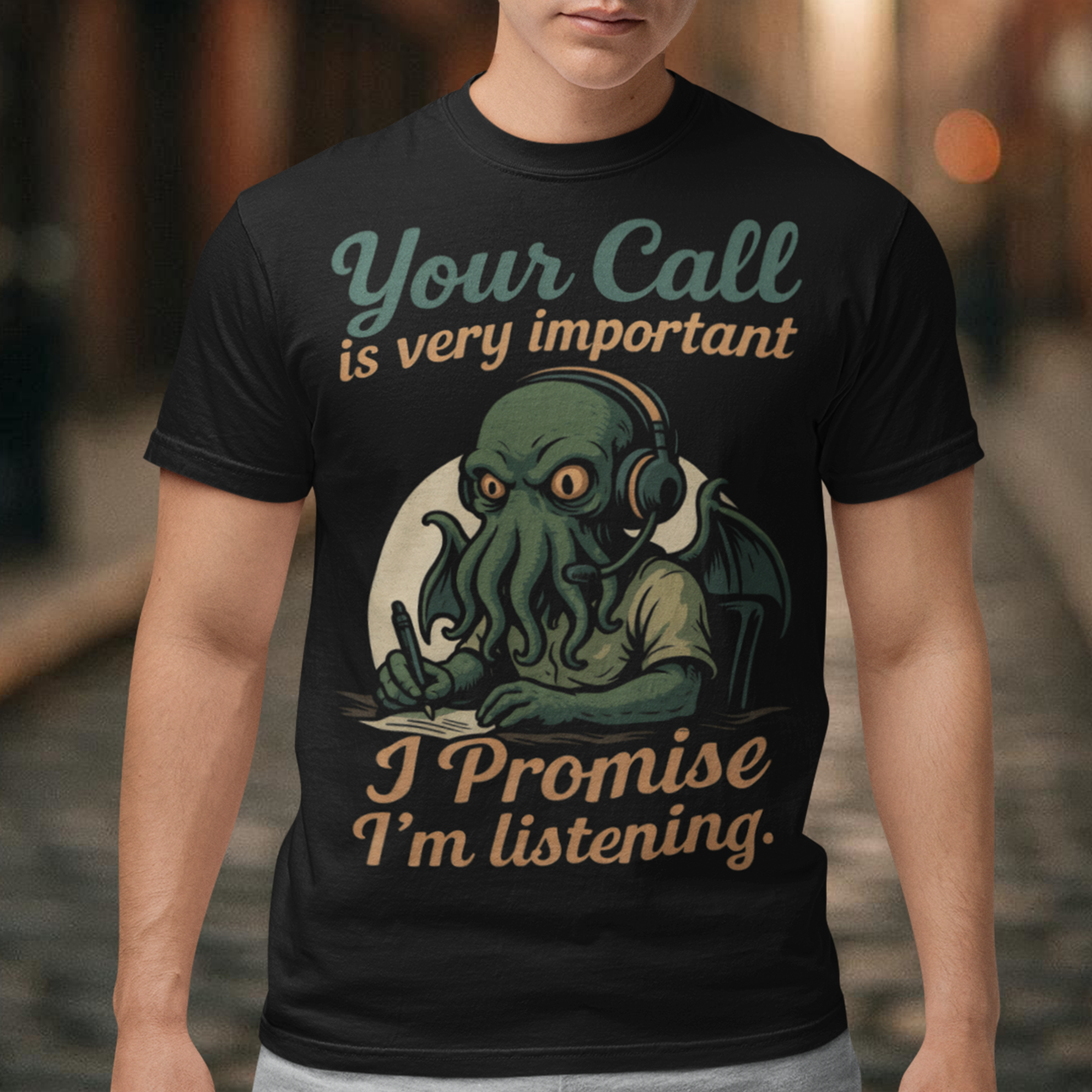 This tee drops Cthulhu into the fluorescent glow of a call centre desk, headset perched, tentacles multitasking like a cosmic customer-service pro. The vintage colors and playful lettering give it a warm, retro hum while the great old one pretends to take notes. It’s a perfect pick for anyone who has survived hold music, worships dark humor, or simply enjoys mythic chaos wrapped in office casual.