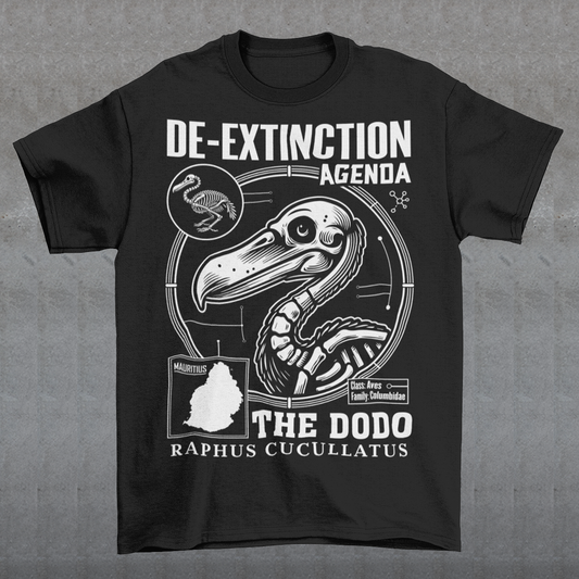 A graphic t-shirt featuring a stylized cartoon illustration of a dodo bird standing proudly with a determined expression. Above the dodo, bold, futuristic text reads “DE-EXTINCTION AGENDA.” The design combines retro and sci-fi elements, suggesting a revival or futuristic mission to bring the extinct bird back to life. The shirt uses vibrant colors and dynamic lines to create a playful yet rebellious aesthetic, appealing to fans of science, nature, or quirky fashion.