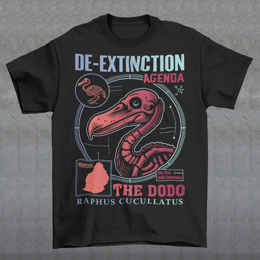 A graphic t-shirt featuring a stylized illustration of a dodo bird, standing upright with a proud, almost defiant expression. The dodo is depicted in vibrant colors, blending realism with a slightly cartoonish flair. Above the bird, bold, capitalized text reads "DE-EXTINCTION AGENDA" in a futuristic font, suggesting a science fiction or activist tone. The design evokes themes of genetic engineering, conservation, and the revival of extinct species. The shirt is a statement piece with humor.