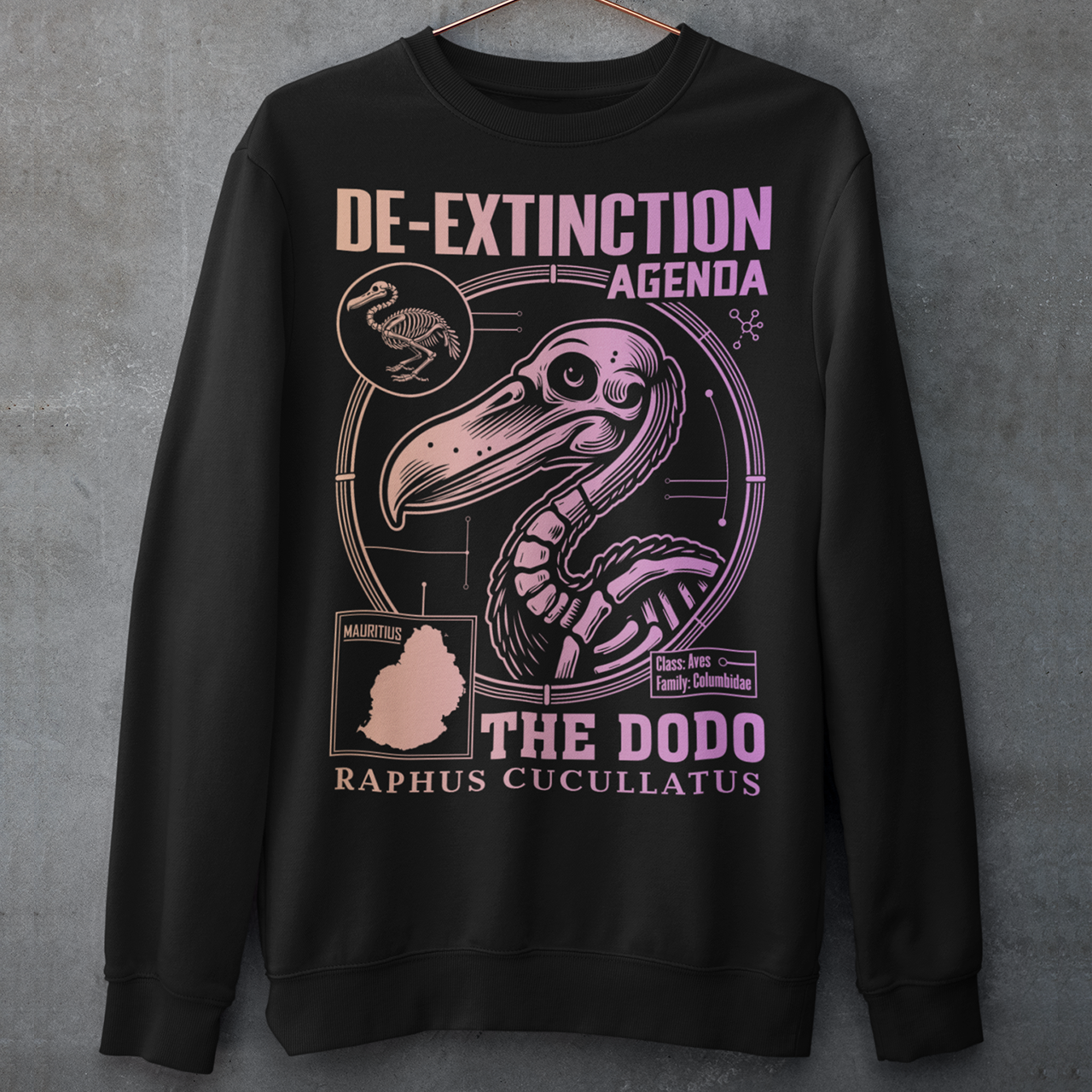 A graphic sweatshirt featuring a stylized illustration of a dodo bird, standing upright with a proud, almost defiant expression. The dodo is depicted in vibrant colors, blending realism with a slightly cartoonish flair. Above the bird, bold, capitalized text reads "DE-EXTINCTION AGENDA" in a futuristic font, suggesting a science fiction or activist tone. The design evokes themes of genetic engineering, conservation, and the revival of extinct species. The shirt is a statement piece with humor.