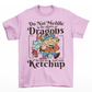 Pink t-shirt of a dragon holding a bottle of ketchup standing behind a viking  with text DO NOT MEDDLE IN THE AFFAIRS OF DRAGONS FOR YOU ARE GOOD WITH KETCHUP.