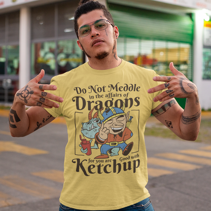Introducing our whimsically fierce and flavorful "Dragon Connoisseur" T-shirt! This eye-catching design features a majestic dragon with a mischievous grin, proudly holding a bottle of ketchup, standing ominously behind a brave Viking. The caption, "DO NOT MEDDLE IN THE AFFAIRS OF DRAGONS FOR YOU ARE GOOD WITH KETCHUP," adds a touch of humor and a warning to all who dare to challenge the fiery and saucy taste preferences of these mythical creatures.