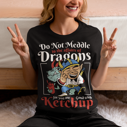 Introducing our whimsically fierce and flavorful "Dragon Connoisseur" T-shirt! This eye-catching design features a majestic dragon with a mischievous grin, proudly holding a bottle of ketchup, standing ominously behind a brave Viking. The caption, "DO NOT MEDDLE IN THE AFFAIRS OF DRAGONS FOR YOU ARE GOOD WITH KETCHUP," adds a touch of humor and a warning to all who dare to challenge the fiery and saucy taste preferences of these mythical creatures.