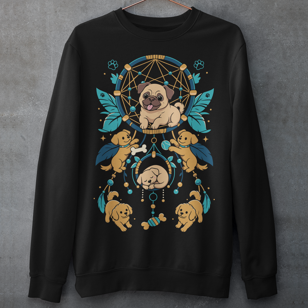 Black sweatshirt featuring a colorful boho dog dreamcatcher design filled with adorable pug puppies. The artwork includes a central pug surrounded by smaller dogs, feathers, beads, paw prints, dog bones, and a sleeping puppy, creating a playful and whimsical pet-themed graphic. Perfect for pug lovers, dog moms, puppy enthusiasts, and fans of cute bohemian dog apparel.