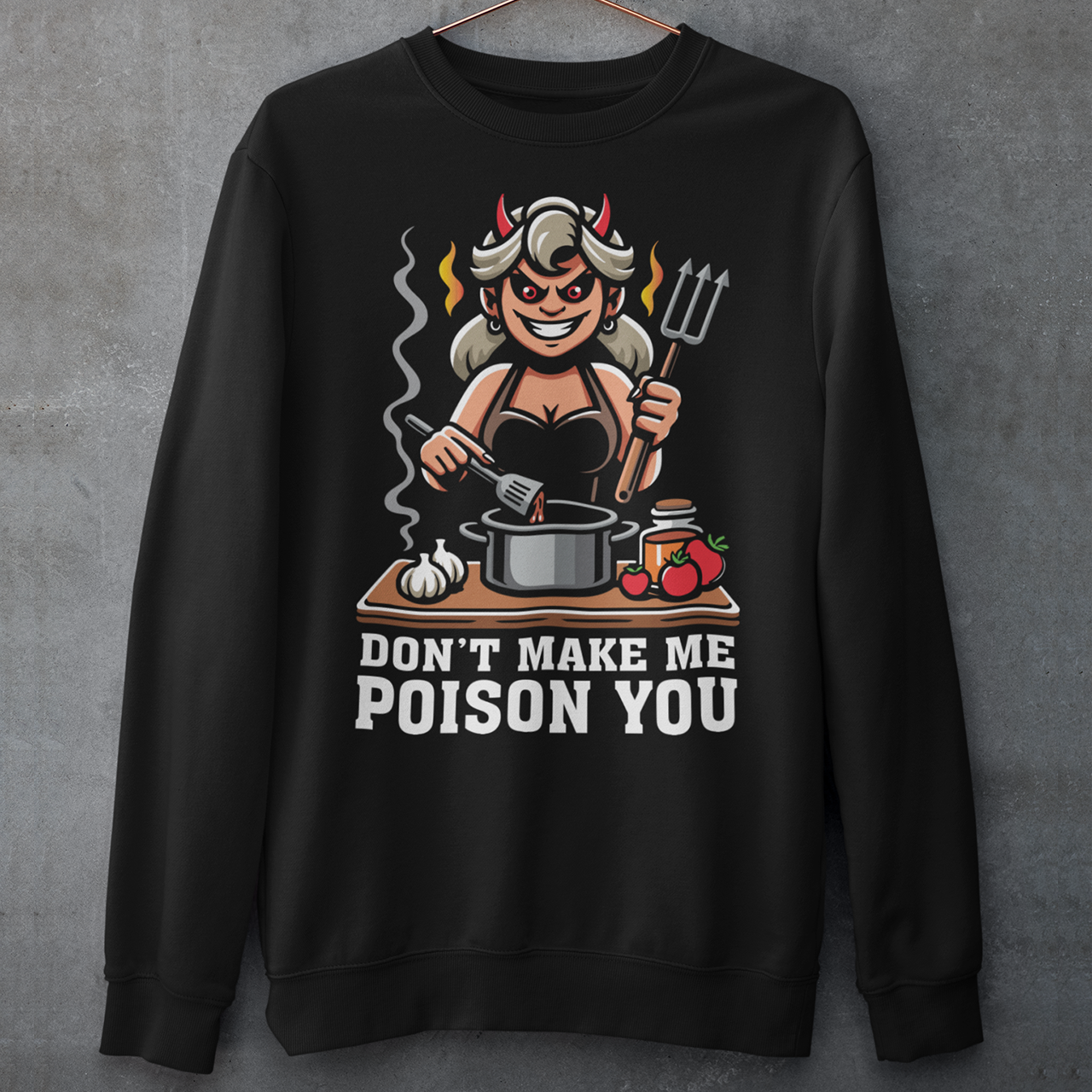 Black sweatshirt of a devil woman cooking food with text underneath DONT MAKE ME POISON YOU.