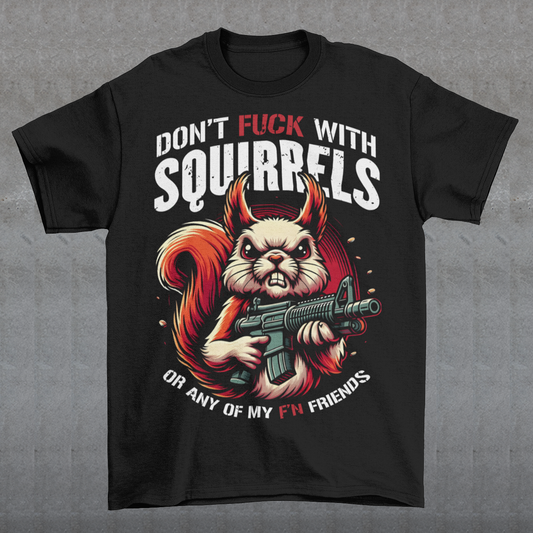 This bold graphic tee features a tough-looking squirrel clutching a pistol, its stance both humorous and a little intimidating. Above the squirrel, in a rugged, distressed font, are the words "DON'T FUCK WITH SQUIRRELS", adding to the edgy vibe of the shirt. Below, the line "OR ANY OF MY F'N FRIENDS" drives the point home, giving the whole design a quirky, rebellious energy. Perfect for animal lovers with a sense of humor or anyone who appreciates a bit of wit and attitude in their wardrobe!