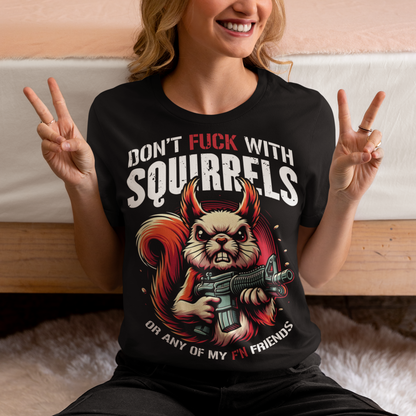 This bold graphic tee features a tough-looking squirrel clutching a pistol, its stance both humorous and a little intimidating. Above the squirrel, in a rugged, distressed font, are the words "DON'T FUCK WITH SQUIRRELS", adding to the edgy vibe of the shirt. Below, the line "OR ANY OF MY F'N FRIENDS" drives the point home, giving the whole design a quirky, rebellious energy. Perfect for animal lovers with a sense of humor or anyone who appreciates a bit of wit and attitude in their wardrobe!