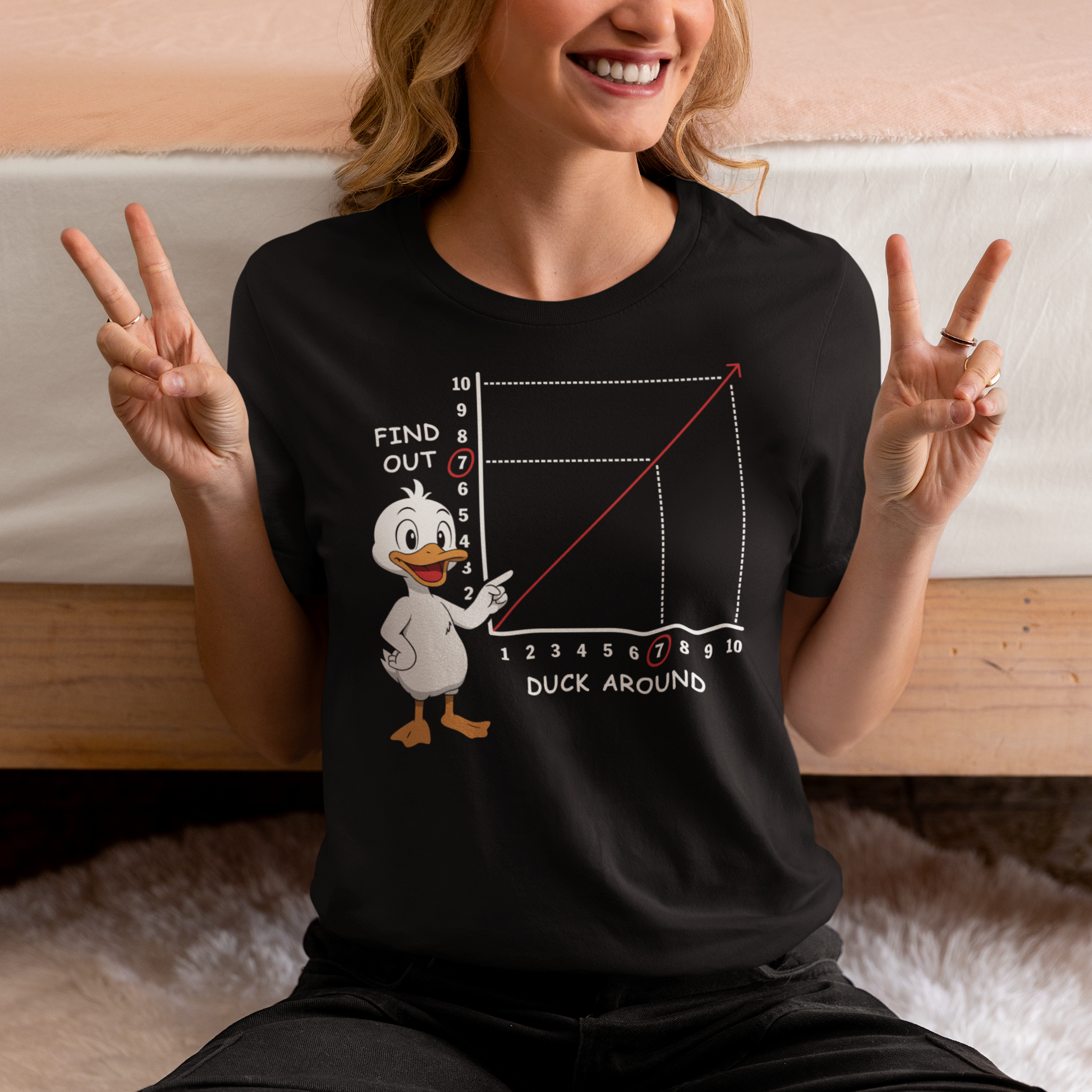Duck Around Find Out T-Shirt - Funny Duck Shirt - Meme Humor Tee. Black t-shirt featuring a cartoon duck pointing at a graph with a rising red line. The chart includes numbers and labels reading “Find Out” on the vertical axis and “Duck Around” on the horizontal axis, with the number 7 highlighted. The design is a humorous visual pun based on a popular phrase, combining a cute duck illustration with a witty, sarcastic chart style.