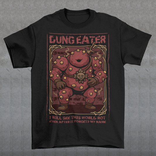 This black t-shirt features a grim, illustrated tribute to one of dark fantasy’s most unsettling figures Dung Eater. The hulking, corrupted character dominates the design, rendered in deep crimson tones with weathered textures and ornate framing that echo cursed tomes and forgotten prophecies. The bold title above and the chilling line below give the artwork the feeling of a forbidden page torn from a doomed legend.