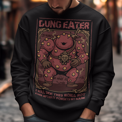 This black sweatshirt features a grim, illustrated tribute to one of dark fantasy’s most unsettling figures Dung Eater. The hulking, corrupted character dominates the design, rendered in deep crimson tones with weathered textures and ornate framing that echo cursed tomes and forgotten prophecies. The bold title above and the chilling line below give the artwork the feeling of a forbidden page torn from a doomed legend.