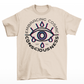 Cream t-shirt of a glitched eye with text around "EMBRACING COSMIC CONSCIOUSNESS".