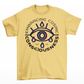 Yellow t-shirt of a glitched eye with text around "EMBRACING COSMIC CONSCIOUSNESS".