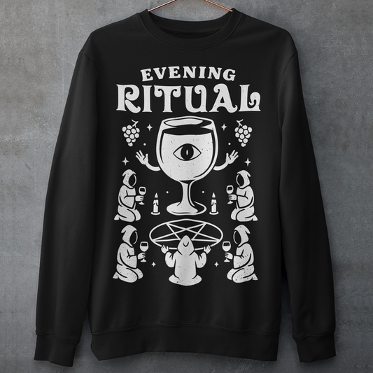 Black sweatshirt featuring a white occult-style graphic with the text “Evening Ritual.” Design shows hooded figures gathered around a pentagram performing a ritual with wine glasses, candles, grapes, and a large mystical wine goblet with an eye symbol. Spooky gothic and illuminati-inspired humor combined with wine lover aesthetics.