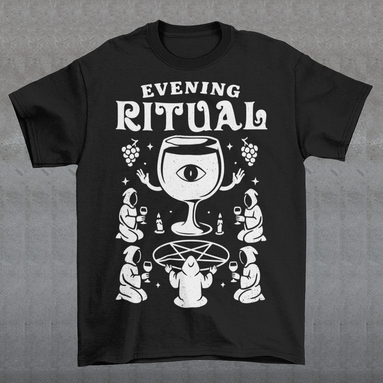 Black t-shirt featuring a white occult-style graphic with the text “Evening Ritual.” Design shows hooded figures gathered around a pentagram performing a ritual with wine glasses, candles, grapes, and a large mystical wine goblet with an eye symbol. Spooky gothic and illuminati-inspired humor combined with wine lover aesthetics.