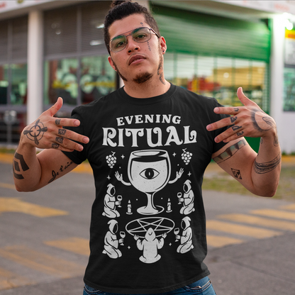Black t-shirt featuring a white occult-style graphic with the text “Evening Ritual.” Design shows hooded figures gathered around a pentagram performing a ritual with wine glasses, candles, grapes, and a large mystical wine goblet with an eye symbol. Spooky gothic and illuminati-inspired humor combined with wine lover aesthetics.