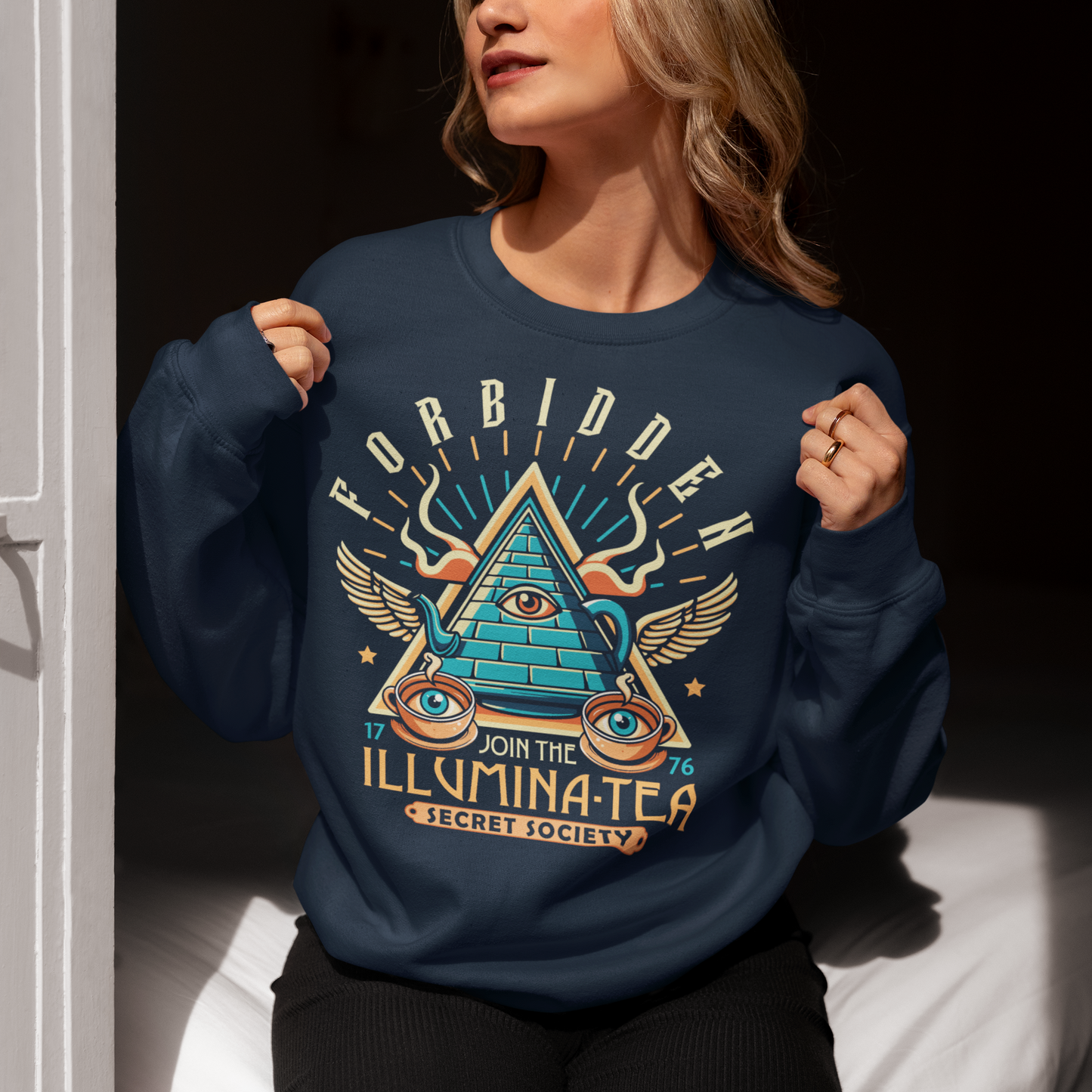 Navy sweatshirt of an Illuminati tea pot and cups with text ILLUMINA-TEA.