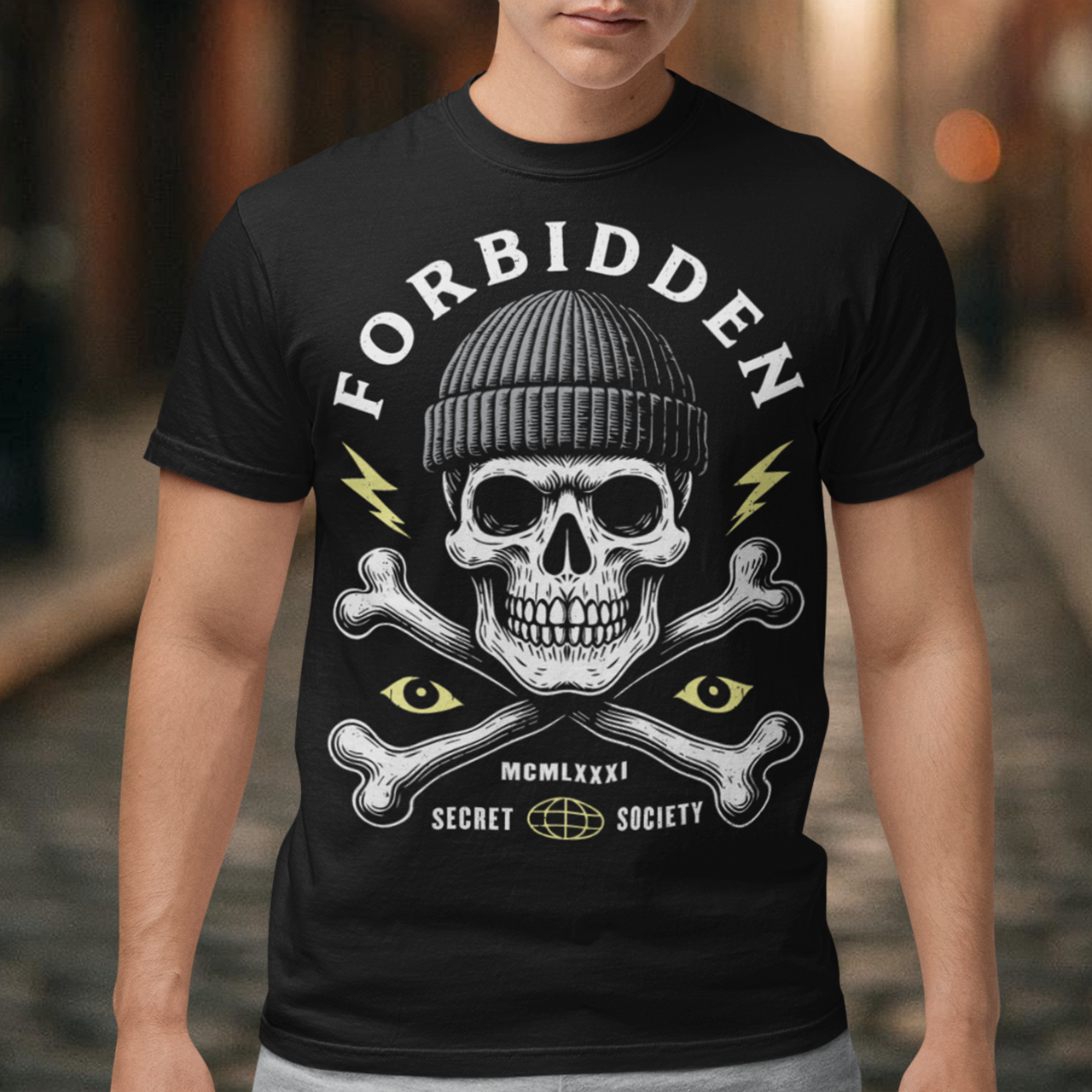 At the center sits a stark skull in a knit beanie, framed by crossed bones, watchful eyes, and crackling lightning bolts. Bold lettering reads Forbidden, with subtle details like Roman numerals and “Secret Society” giving the design the air of an underground emblem or outlaw insignia. The muted cream and acid-yellow accents pop against the black fabric, creating a gritty, modern occult aesthetic.