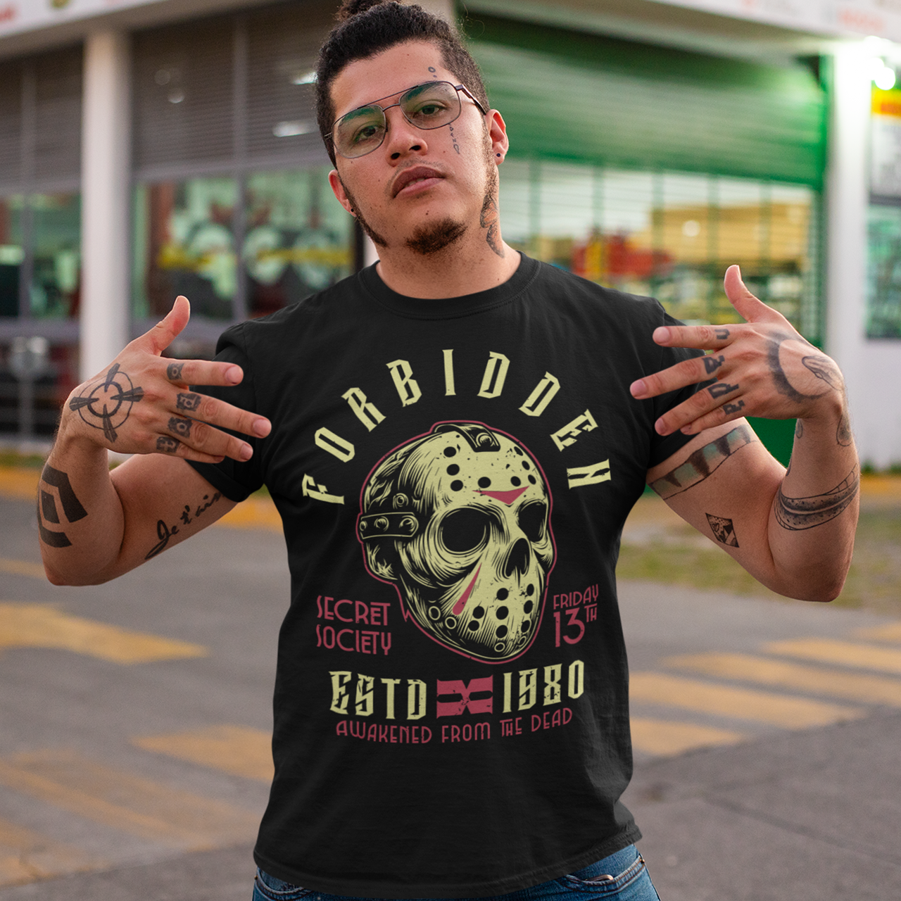 Get ready to turn heads with this spine-chilling t-shirt featuring a graphic of a sinister, battle-worn hockey mask. Around the mask, the text "FORBIDDEN SECRET SOCIETY AWAKENED FROM THE DEAD" looms in jagged, eerie lettering. The design has a gritty, distressed style, evoking an unsettling sense of mystery and menace. Perfect for horror enthusiasts, this shirt brings a dark aesthetic and an air of the supernatural, making it a must-have for those who like their fashion on the dark side.