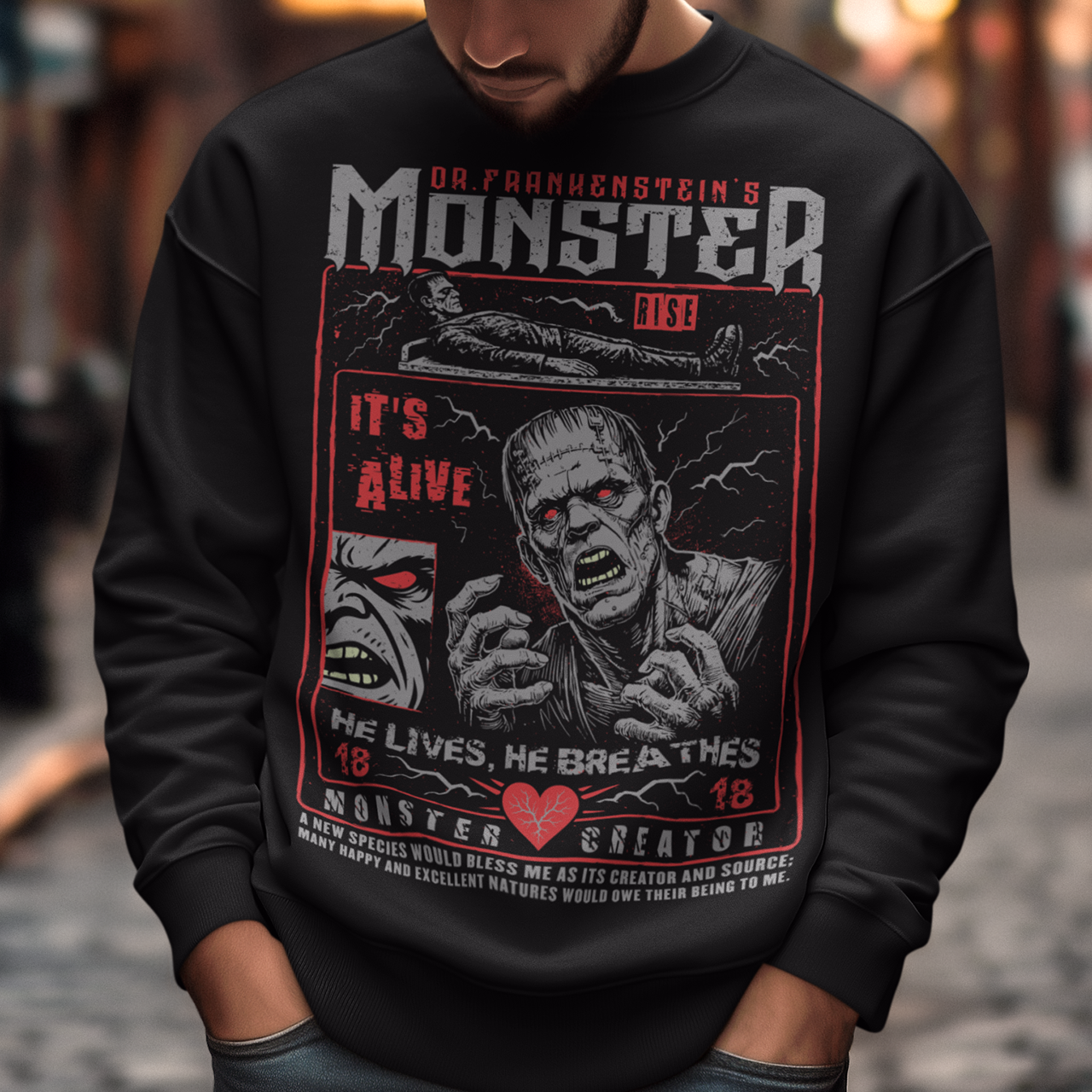 Black horror-themed sweatshirt featuring a vintage Frankenstein monster graphic in distressed gray print. The design includes comic-style panels with lightning bolts, Dr. Frankenstein’s monster rising from a lab table, and bold text reading “It’s Alive.” Gothic typography and retro horror artwork give the shirt a classic monster movie aesthetic, perfect for Halloween, horror fans, gothic fashion lovers, and collectors of vintage spooky apparel.