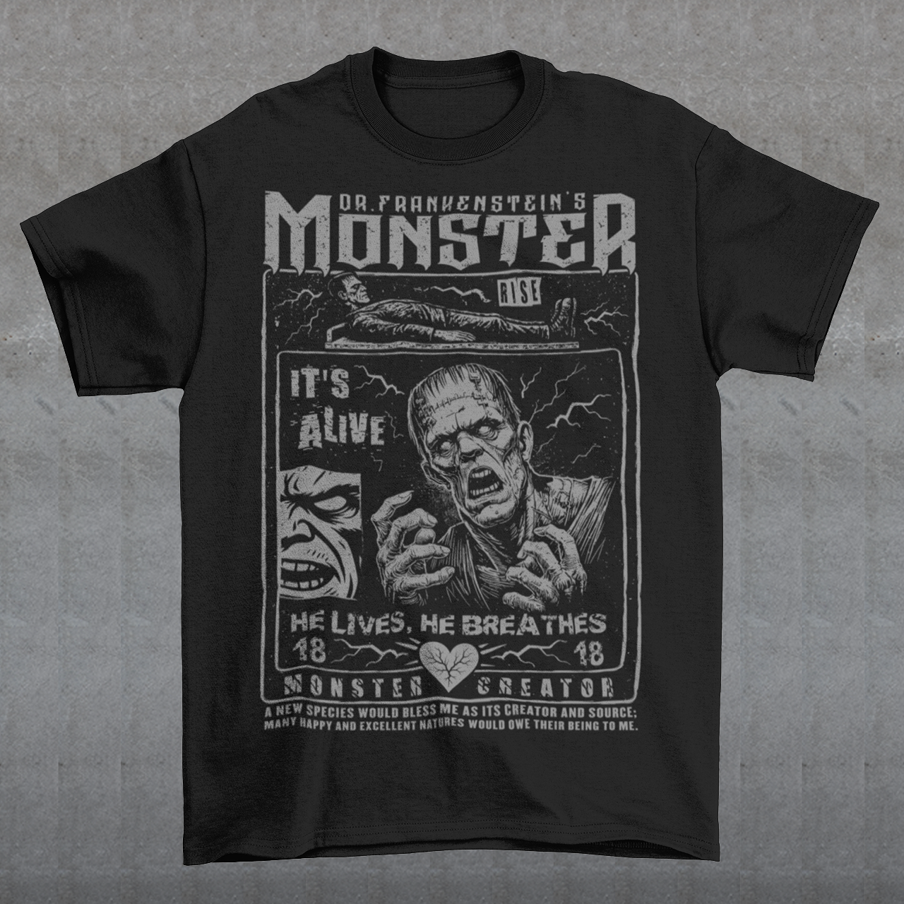 Black horror-themed t-shirt featuring a vintage Frankenstein monster graphic in distressed gray print. The design includes comic-style panels with lightning bolts, Dr. Frankenstein’s monster rising from a lab table, and bold text reading “It’s Alive.” Gothic typography and retro horror artwork give the shirt a classic monster movie aesthetic, perfect for Halloween, horror fans, gothic fashion lovers, and collectors of vintage spooky apparel.