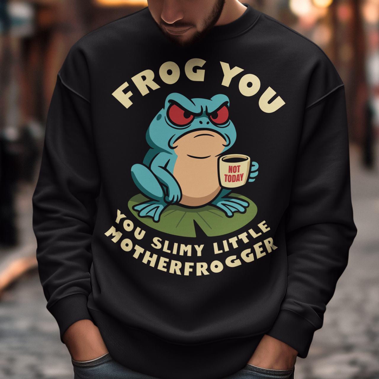 Frog You Motherfrogger Sweathirt - Angry Frog Shirt - Funny Animal Meme Top - Frog Lover Gift. Serve attitude with a side of caffeine in this bold and hilarious “Frog Off Motherfrogger” shirt. Featuring a grumpy frog perched on a lily pad, clutching a “Not Today” coffee mug, this design perfectly captures those moods when patience is low and sarcasm is high. With its cheeky wordplay and expressive character, it’s the ultimate statement piece for anyone who appreciates humor with a bite.