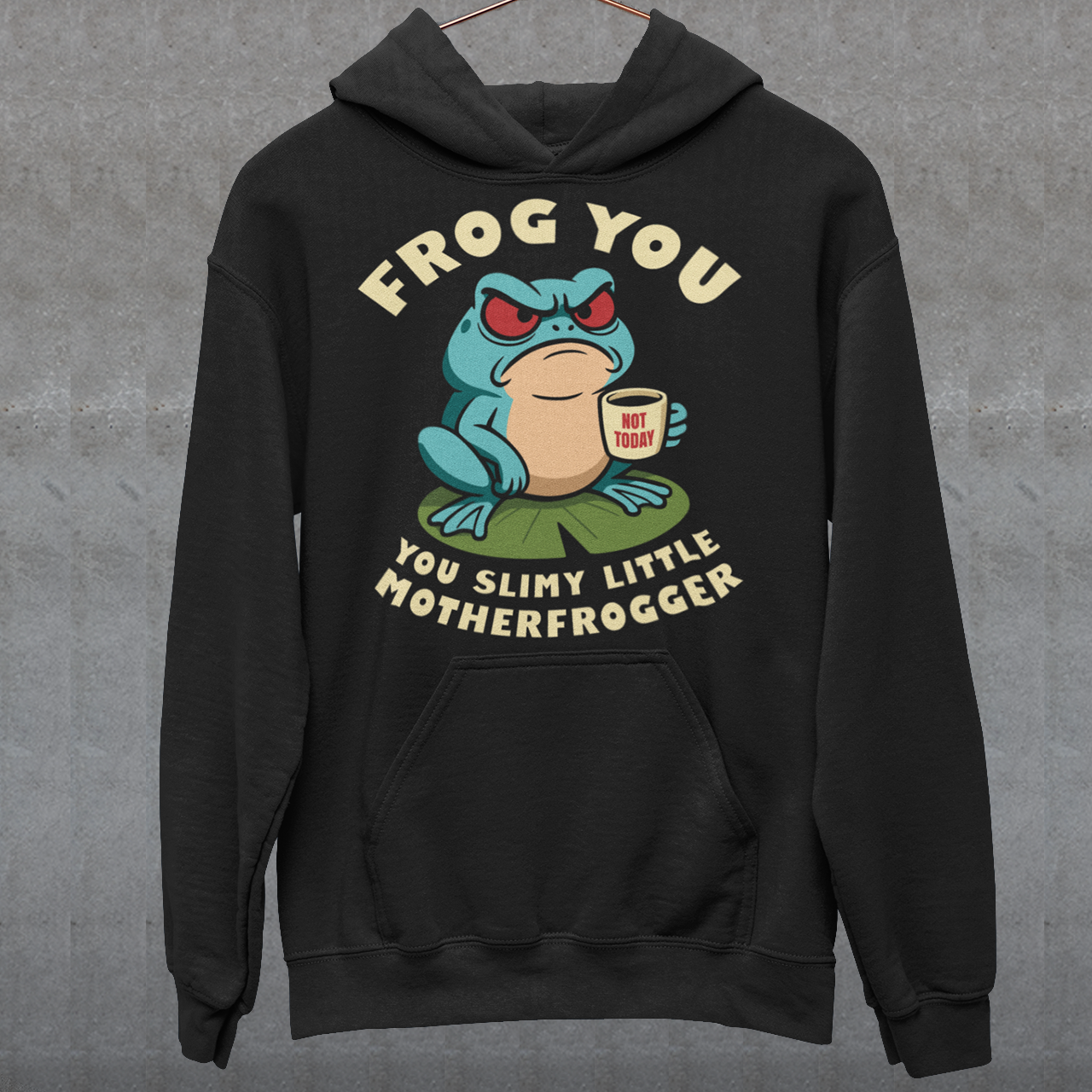 Frog You Motherfrogger hoodie - Angry Frog Shirt - Funny Animal Meme Top - Frog Lover Gift. Serve attitude with a side of caffeine in this bold and hilarious “Frog Off Motherfrogger” hoodie. Featuring a grumpy frog perched on a lily pad, clutching a “Not Today” coffee mug, this design perfectly captures those moods when patience is low and sarcasm is high. With its cheeky wordplay and expressive character, it’s the ultimate statement piece for anyone who appreciates humor with a bite.