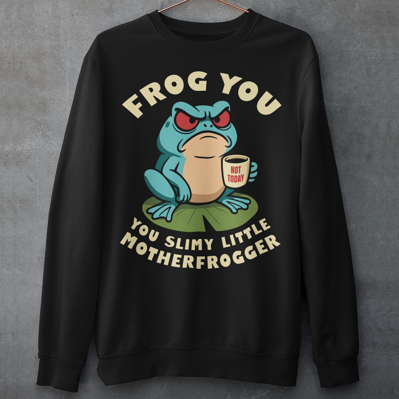 Frog You Motherfrogger Sweathirt - Angry Frog Shirt - Funny Animal Meme Top - Frog Lover Gift. Serve attitude with a side of caffeine in this bold and hilarious “Frog Off Motherfrogger” shirt. Featuring a grumpy frog perched on a lily pad, clutching a “Not Today” coffee mug, this design perfectly captures those moods when patience is low and sarcasm is high. With its cheeky wordplay and expressive character, it’s the ultimate statement piece for anyone who appreciates humor with a bite.
