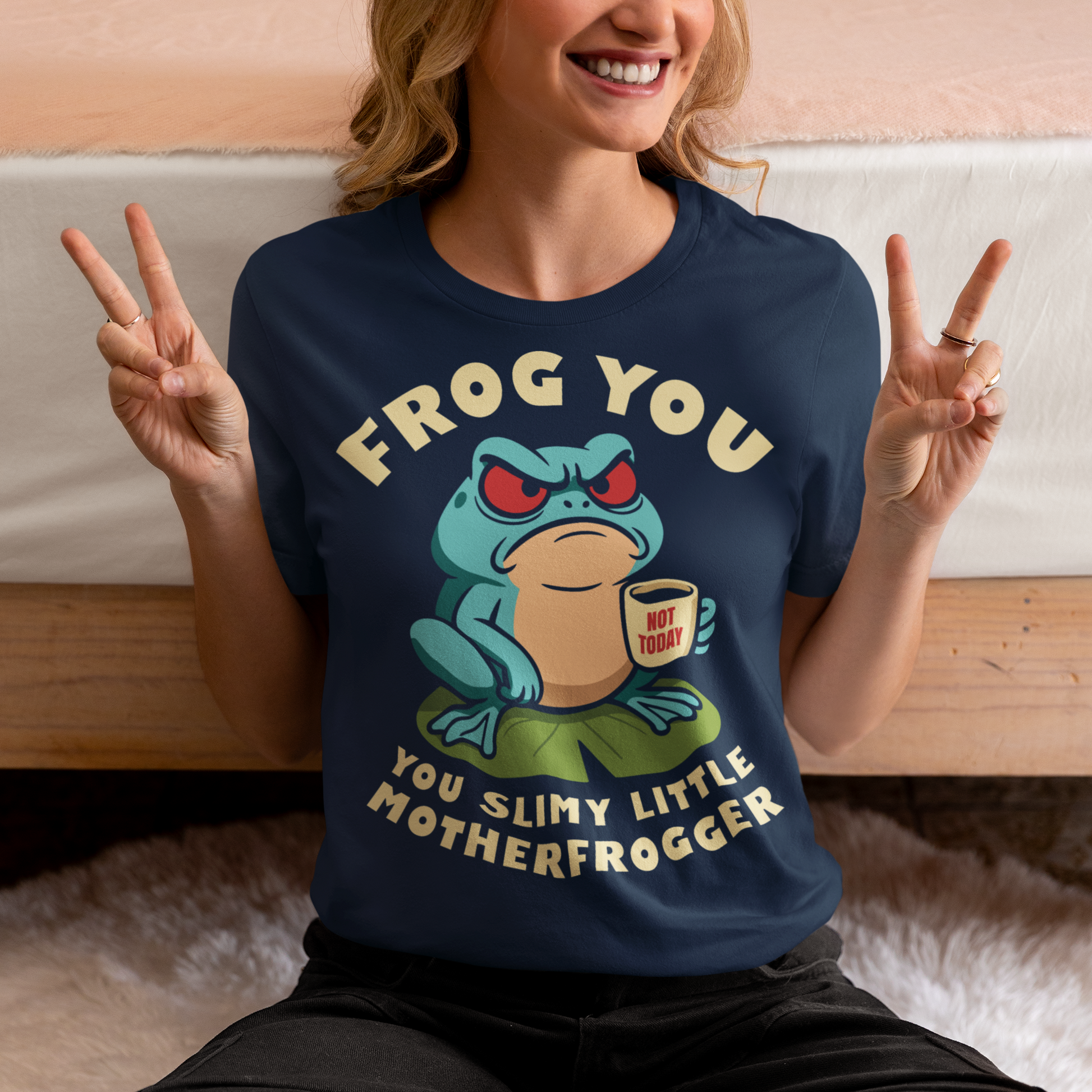 Frog You Motherfrogger T-Shirt - Angry Frog Shirt - Funny Animal Meme Tee - Frog Lover Gift. Serve attitude with a side of caffeine in this bold and hilarious “Frog Off Motherfrogger” shirt. Featuring a grumpy frog perched on a lily pad, clutching a “Not Today” coffee mug, this design perfectly captures those moods when patience is low and sarcasm is high. With its cheeky wordplay and expressive character, it’s the ultimate statement piece for anyone who appreciates humor with a bite.