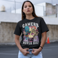 Black t-shirt of a zombie and skeleton sitting on tombstones gaming with text "GAMER'S NEVER DIE!".