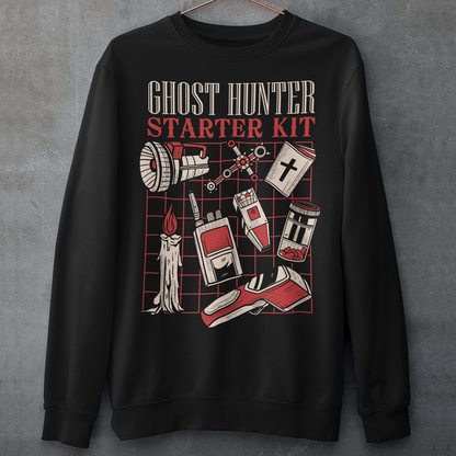 Step into the shadows with this Ghost Hunter Starter Kit sweatshirt, a perfect blend of spooky humor and paranormal adventure. Designed for fans of ghost hunting, horror culture, and all things supernatural, this bold graphic tee features a vintage-style layout packed with classic ghost hunting essentials like an EMF reader, flashlight, candle, spirit box, holy book, and more. The striking red and off-white artwork pops against the black fabric, giving it a retro paranormal investigator vibe.