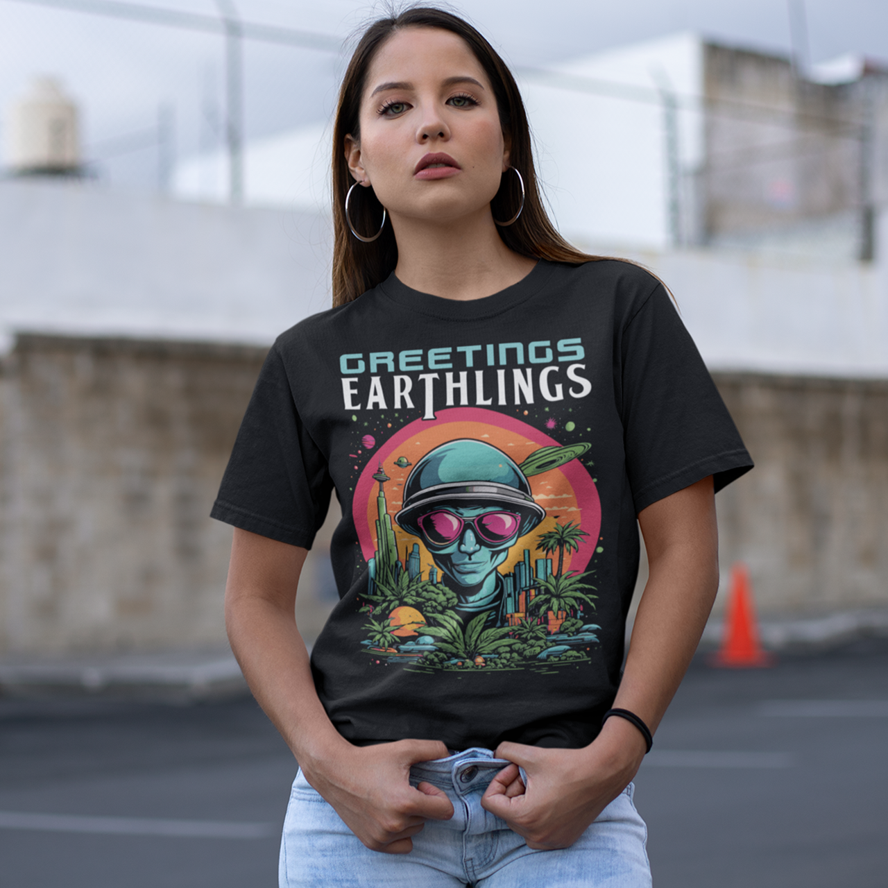 Black t-shirt of an alien with text "GREETINGS EARTHLINGS".