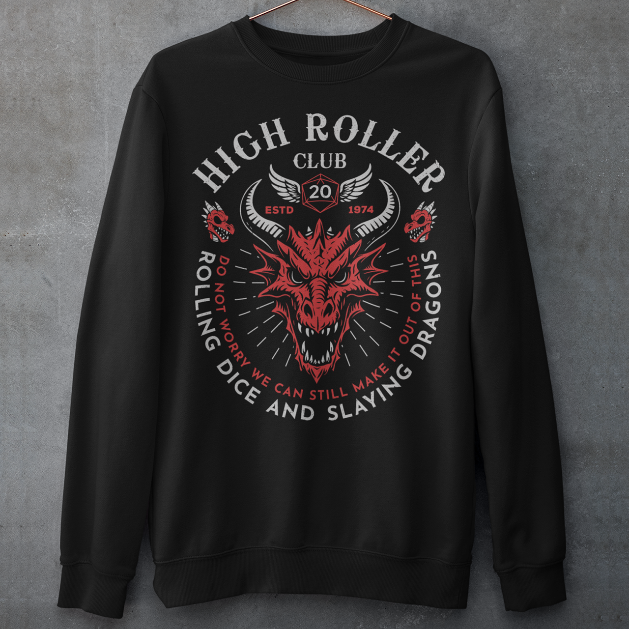 Step into legend status with the High Roller Club sweatshirt, forged for dice slingers, dragon slayers, and tabletop tacticians who play big and roll fearless. Featuring a fierce dragon crest and bold D20 iconography, this design salutes those who know fortune favors the bold and sometimes the wildly unprepared. Cozy enough for late night campaigns and intimidating enough for the gaming table, it’s built for crits, curses, and clutch saves alike. 