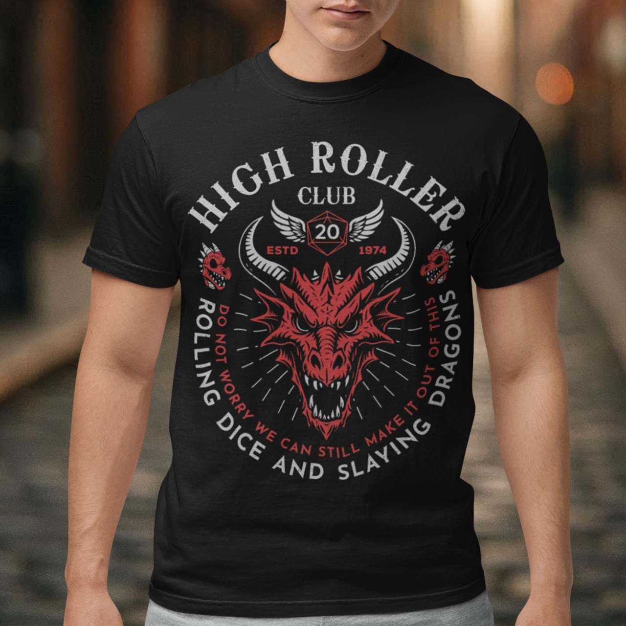 Step into legend status with the High Roller Club t-shirt, forged for dice slingers, dragon slayers, and tabletop tacticians who play big and roll fearless. Featuring a fierce dragon crest and bold D20 iconography, this design salutes those who know fortune favors the bold and sometimes the wildly unprepared. Cozy enough for late night campaigns and intimidating enough for the gaming table, it’s built for crits, curses, and clutch saves alike.