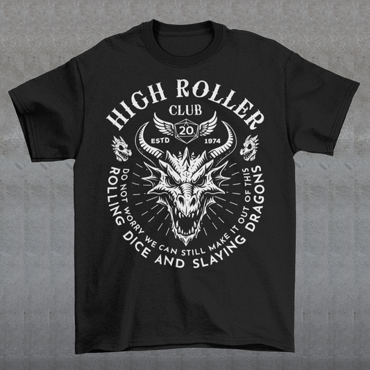 Step into legend status with the High Roller Club t-shirt, forged for dice slingers, dragon slayers, and tabletop tacticians who play big and roll fearless. Featuring a fierce dragon crest and bold D20 iconography, this design salutes those who know fortune favors the bold and sometimes the wildly unprepared. Cozy enough for late night campaigns and intimidating enough for the gaming table, it’s built for crits, curses, and clutch saves alike. Whether you’re a dungeon master pulling strings or a player chas