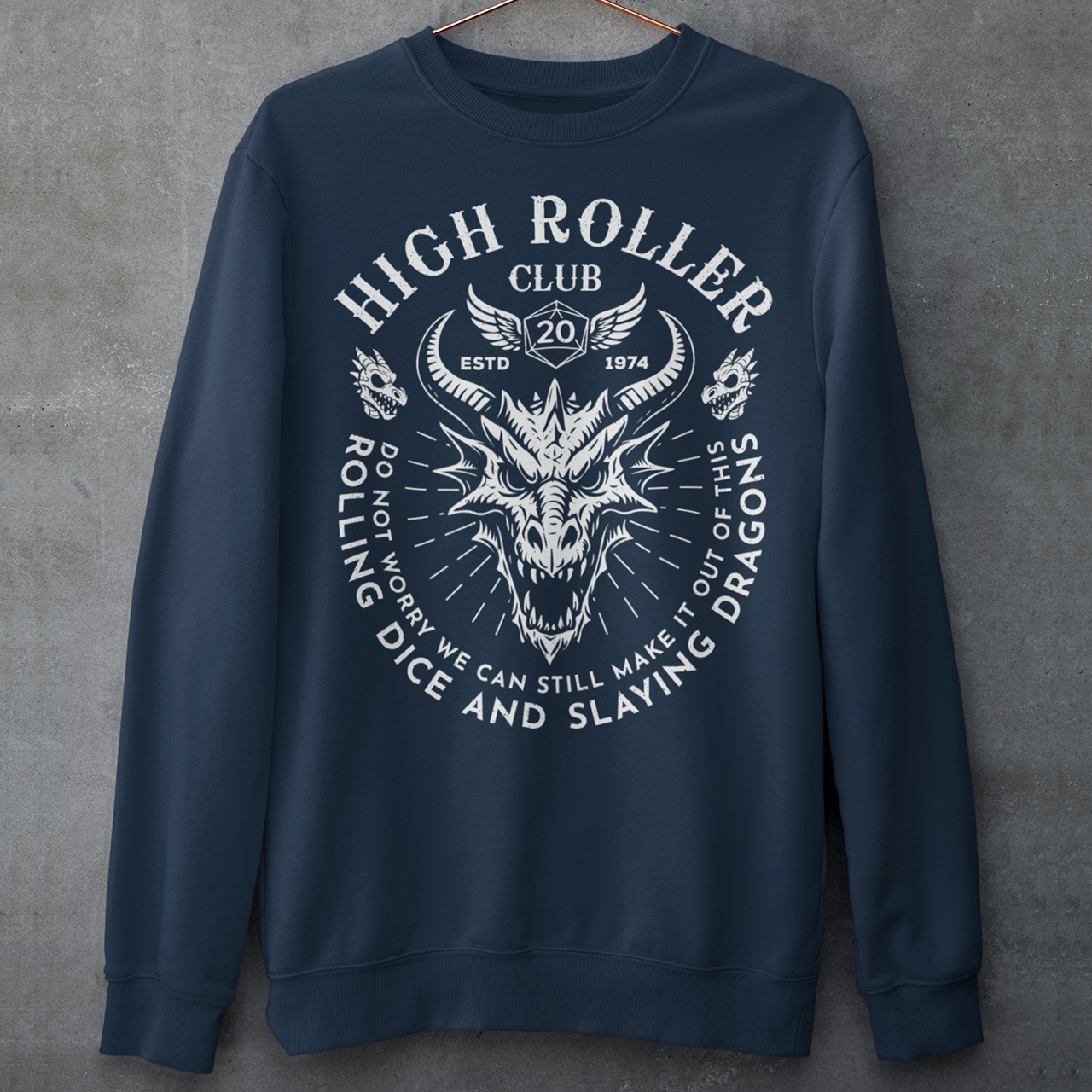 Step into legend status with the High Roller Club sweatshirt, forged for dice slingers, dragon slayers, and tabletop tacticians who play big and roll fearless. Featuring a fierce dragon crest and bold D20 iconography, this design salutes those who know fortune favors the bold and sometimes the wildly unprepared. Cozy enough for late night campaigns and intimidating enough for the gaming table, it’s built for crits, curses, and clutch saves alike. 