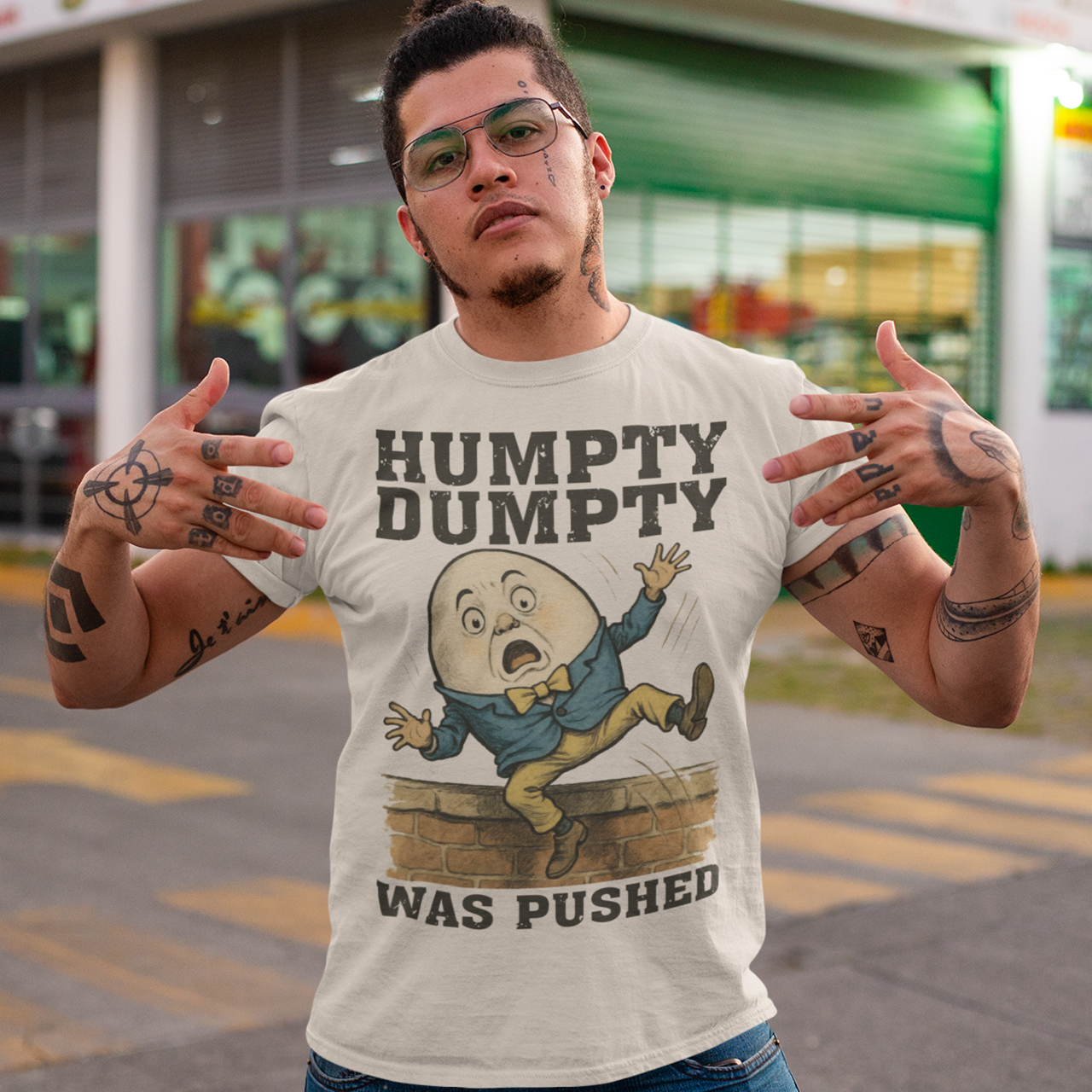 Make a bold statement with our "Humpty Dumpty Was Pushed" T-shirt — a clever twist on the classic nursery rhyme. Featuring a playful yet rebellious design of Humpty Dumpty mid-fall from his iconic wall, this shirt mixes dark humor with nostalgic charm. Perfect for anyone who loves witty graphics, conspiracy-style humor, or just wants to spark a few laughs and double-takes.