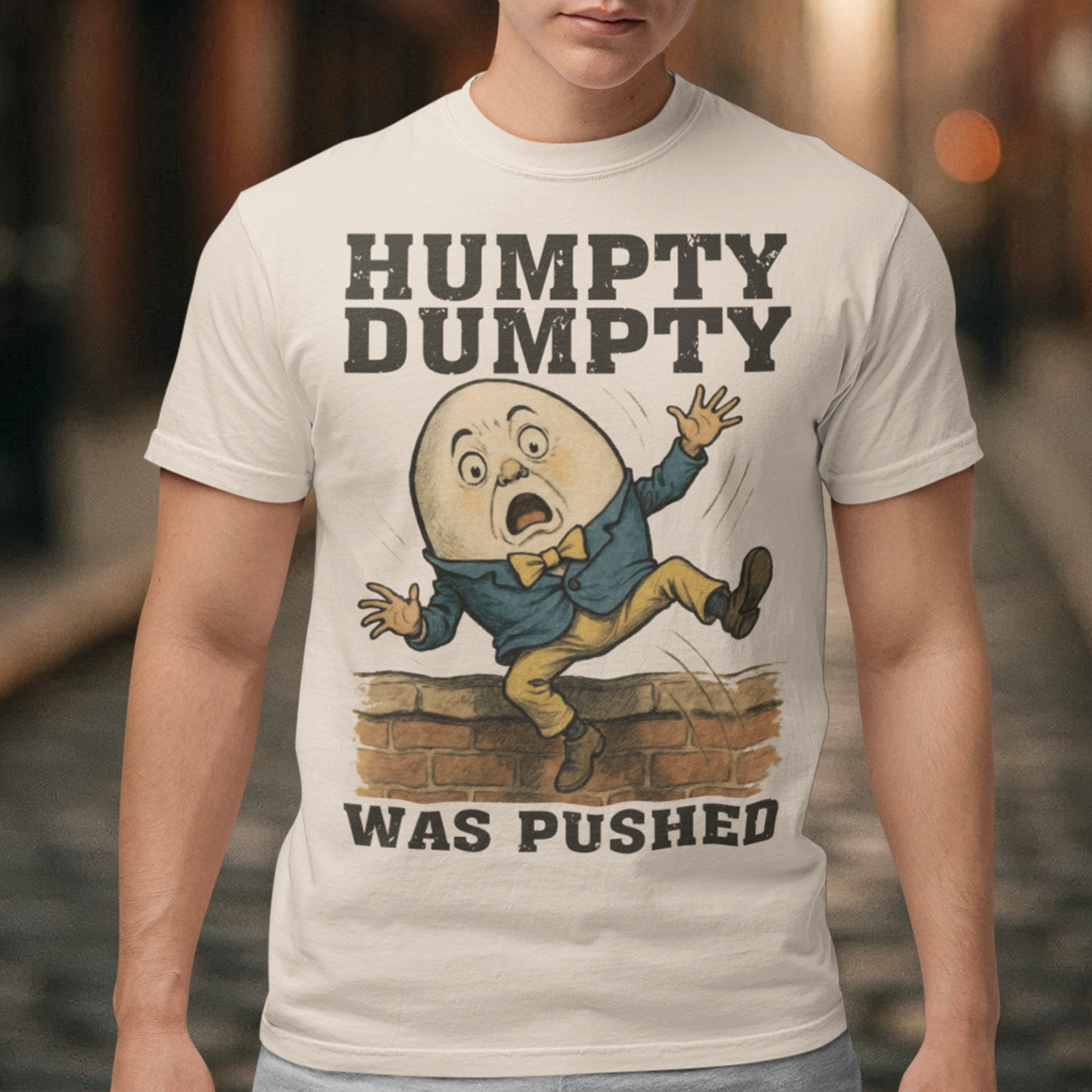 Make a bold statement with our "Humpty Dumpty Was Pushed" T-shirt — a clever twist on the classic nursery rhyme. Featuring a playful yet rebellious design of Humpty Dumpty mid-fall from his iconic wall, this shirt mixes dark humor with nostalgic charm. Perfect for anyone who loves witty graphics, conspiracy-style humor, or just wants to spark a few laughs and double-takes.
