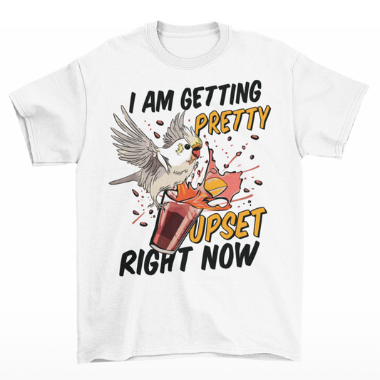 White t-shirt of cockatoo knocking over a cocktail with text underneath "I AM GETTING PRETTY UPSET RIGHT NOW".