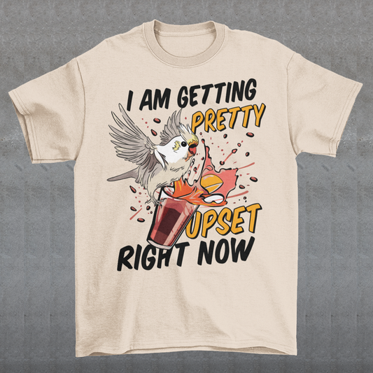 Introducing our whimsical and vibrant t-shirt featuring a mischievous cockatoo caught in a comical escapade. This design captures the playful spirit of this feathered troublemaker as it gleefully knocks over a meticulously crafted cocktail, sending colorful liquids splashing in all directions. The image perfectly portrays the unpredictable and endearing nature of these intelligent birds.
