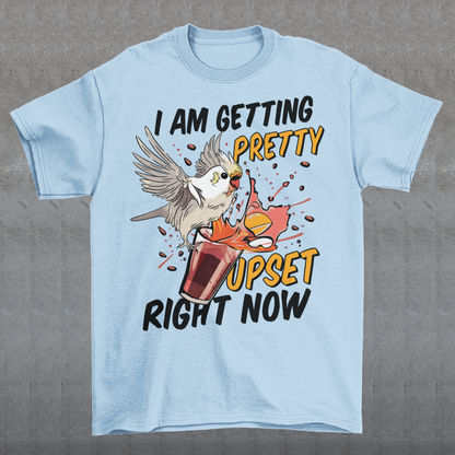 Introducing our whimsical and vibrant t-shirt featuring a mischievous cockatoo caught in a comical escapade. This design captures the playful spirit of this feathered troublemaker as it gleefully knocks over a meticulously crafted cocktail, sending colorful liquids splashing in all directions. The image perfectly portrays the unpredictable and endearing nature of these intelligent birds.