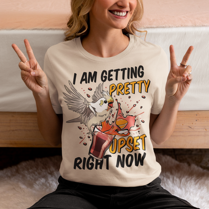 Introducing our whimsical and vibrant t-shirt featuring a mischievous cockatoo caught in a comical escapade. This design captures the playful spirit of this feathered troublemaker as it gleefully knocks over a meticulously crafted cocktail, sending colorful liquids splashing in all directions. The image perfectly portrays the unpredictable and endearing nature of these intelligent birds.