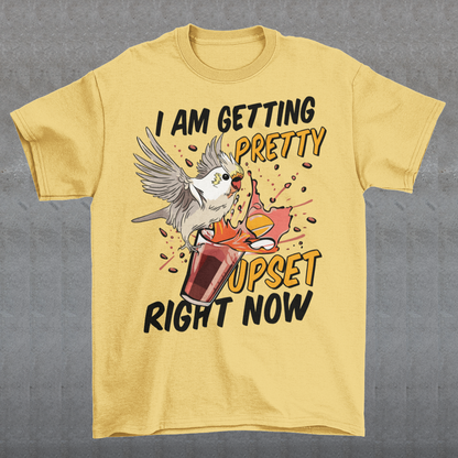 Introducing our whimsical and vibrant t-shirt featuring a mischievous cockatoo caught in a comical escapade. This design captures the playful spirit of this feathered troublemaker as it gleefully knocks over a meticulously crafted cocktail, sending colorful liquids splashing in all directions. The image perfectly portrays the unpredictable and endearing nature of these intelligent birds.