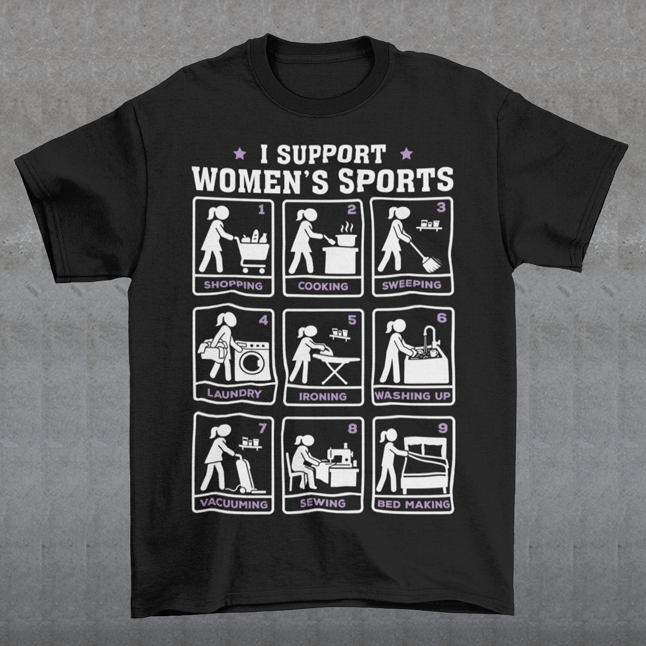 Black t-shirt featuring the humorous phrase “I SUPPORT WOMEN’S SPORTS” with nine illustrated panels parodying different household activities: shopping, cooking, sweeping, laundry, ironing, washing up, vacuuming, sewing, and bed making. White and purple graphics create a retro sports-style design with a sarcastic, tongue-in-cheek theme.
