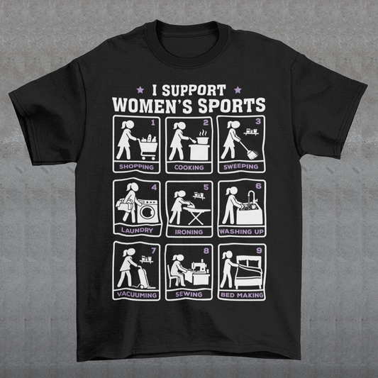Black t-shirt featuring the humorous phrase “I SUPPORT WOMEN’S SPORTS” with nine illustrated panels parodying different household activities: shopping, cooking, sweeping, laundry, ironing, washing up, vacuuming, sewing, and bed making. White and purple graphics create a retro sports-style design with a sarcastic, tongue-in-cheek theme.