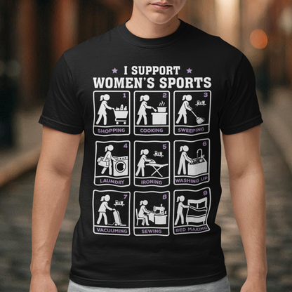 Black t-shirt featuring the humorous phrase “I SUPPORT WOMEN’S SPORTS” with nine illustrated panels parodying different household activities: shopping, cooking, sweeping, laundry, ironing, washing up, vacuuming, sewing, and bed making. White and purple graphics create a retro sports-style design with a sarcastic, tongue-in-cheek theme.